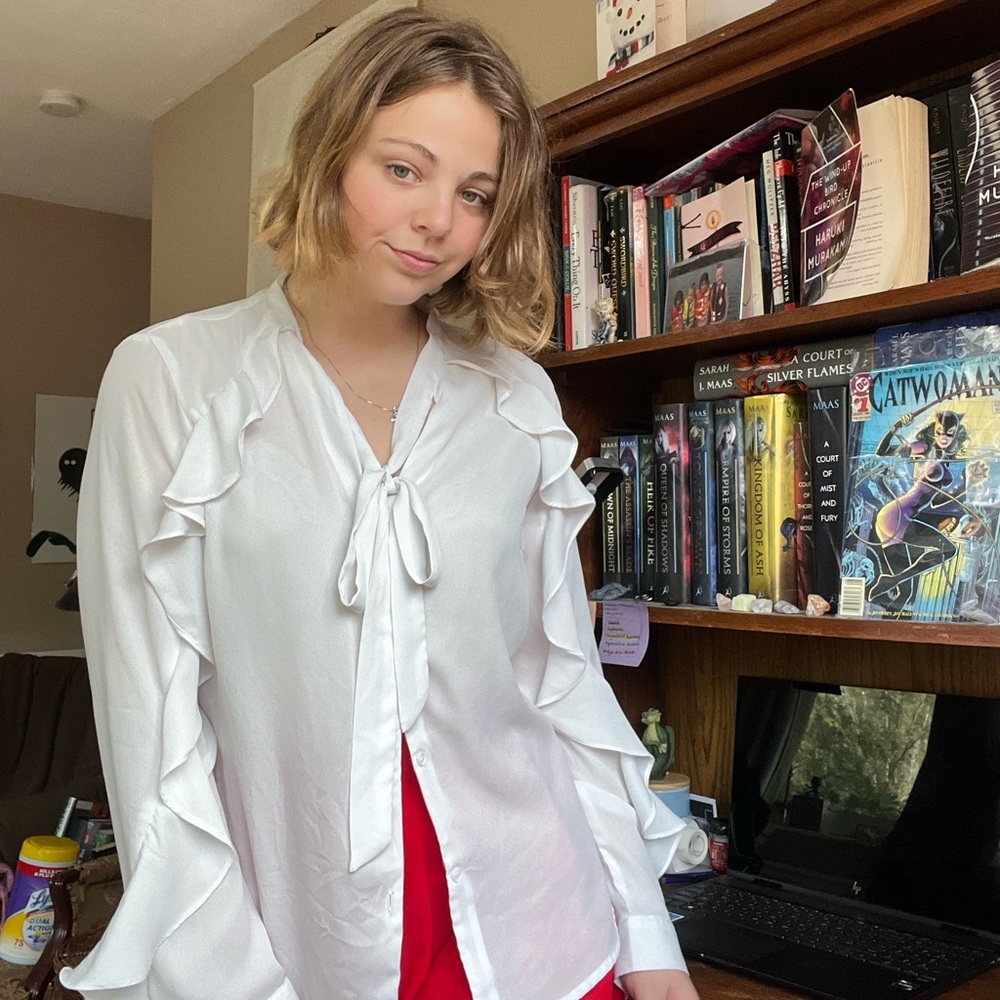 Small white blouse with ruffles and bow